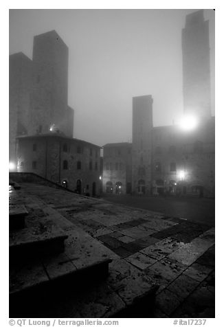 Piazza del Duomo at dawn in the fog. San Gimignano, Tuscany, Italy (black and white)