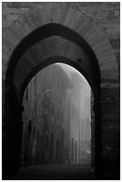 Arch at dawn in the fog. San Gimignano, Tuscany, Italy (black and white)