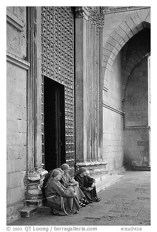 Nuns sit outside of one of  many churches of the historic town. Naples, Campania, Italy