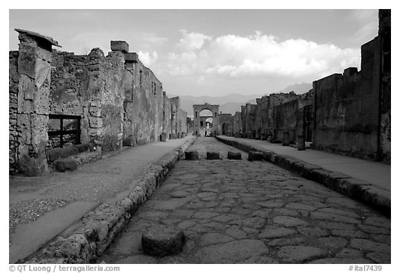 Street with roman period pavement and sidewalks. Pompeii, Campania, Italy (black and white)