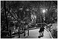Couple walking down Namsan stairs by night. Seoul, South Korea (black and white)