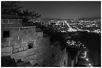 Rampart wall and city lights, Suwon Hwaseong Fortress. South Korea ( black and white)