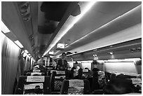 Hostess walking inside high speed KTX train car. Seoul, South Korea ( black and white)