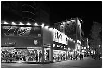 Pedestrian street lined up with outdoor equipment stores. Daegu, South Korea (black and white)