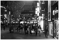 Shoppers strolling on pedestrian street at night. Daegu, South Korea (black and white)