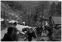 Hikers receiving sacred bread at Sangseonam hermitage, Mt Namsan. Gyeongju, South Korea (black and white)