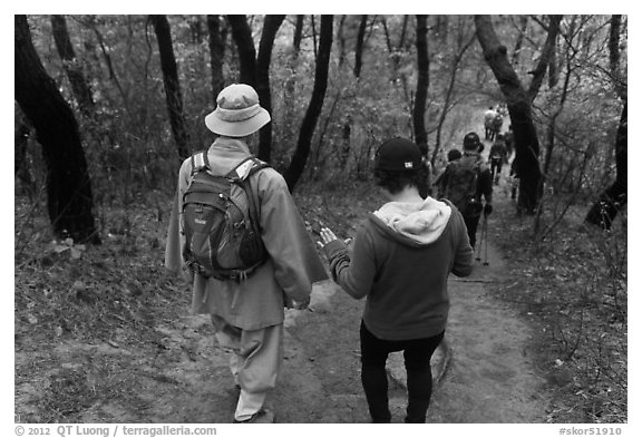 Monk and hikers on trail, Namsan Mountain. Gyeongju, South Korea