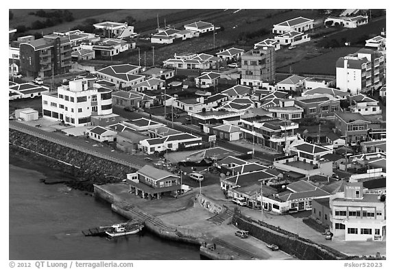 Houses with blue roofs, Seongsang Ilchulbong from above. Jeju Island, South Korea (black and white)