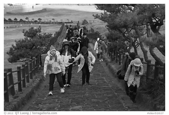 Tourists walking up path, Ilchulbong. Jeju Island, South Korea (black and white)