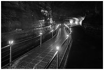 Walkway in Geomunoreum cave with world heritage logos. Jeju Island, South Korea (black and white)