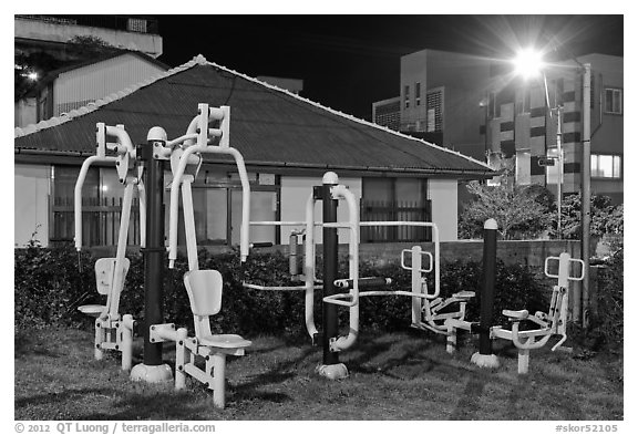 Exercise equipment in yard at night, Seogwipo. Jeju Island, South Korea