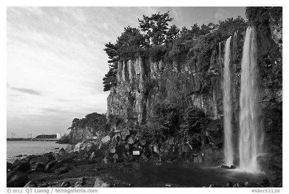 Jeongbang Pokpo, only waterfall in Asia dropping into sea, Seogwipo. Jeju Island, South Korea (black and white)
