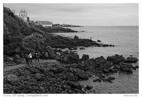 Tourists at Yongduam Rock, Jeju-si. Jeju Island, South Korea (black and white)