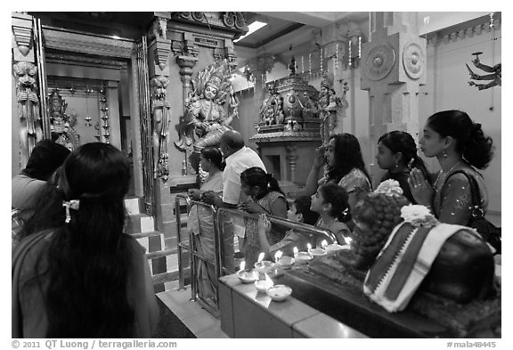Devotees inside Tamil Nadu temple. George Town, Penang, Malaysia (black and white)