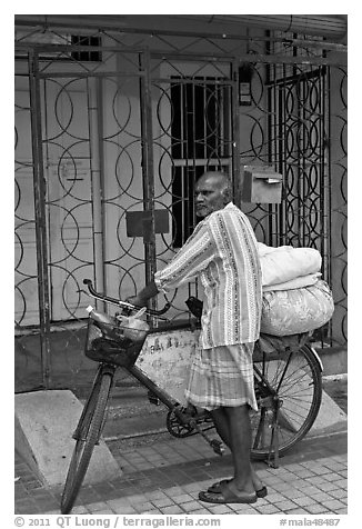 Malay with loaded bicycle. George Town, Penang, Malaysia
