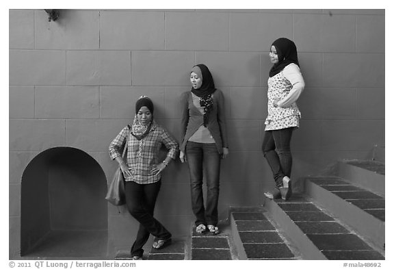 Young women with islamic headscarfs and modern fashions. Malacca City, Malaysia (black and white)