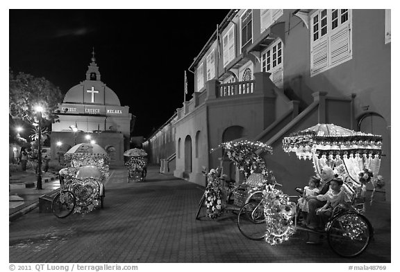 Illuminated trishaws on Town Square at night. Malacca City, Malaysia (black and white)
