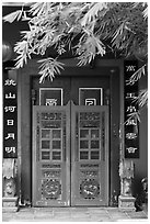 Weathered door with chinese signs and lanterns. Malacca City, Malaysia (black and white)