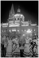 Men and women in traditional mexican costume with Cathedral in background. Guadalajara, Jalisco, Mexico (black and white)