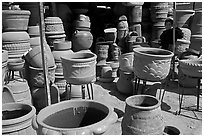Boy standing next to clay pots, Tonala. Jalisco, Mexico (black and white)