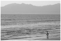 Woman holding children on the beach at sunset, Nuevo Vallarta, Nayarit. Jalisco, Mexico (black and white)