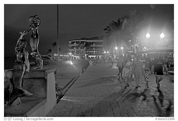 People strolling on the Malecon at night, Puerto Vallarta, Jalisco. Jalisco, Mexico (black and white)
