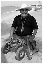 Man without legs  smiling on the Malecon, Puerto Vallarta, Jalisco. Jalisco, Mexico (black and white)