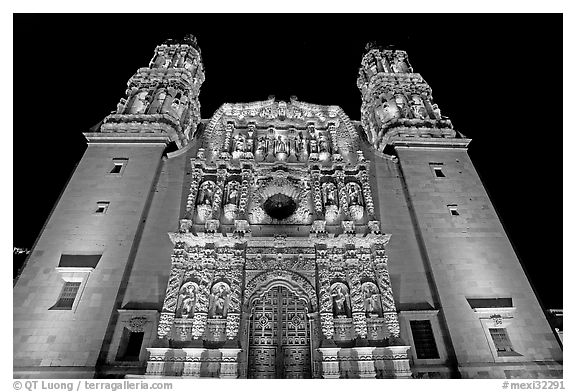 Illuminated facade of Cathdedral laced with Churrigueresque carvings at night. Zacatecas, Mexico (black and white)