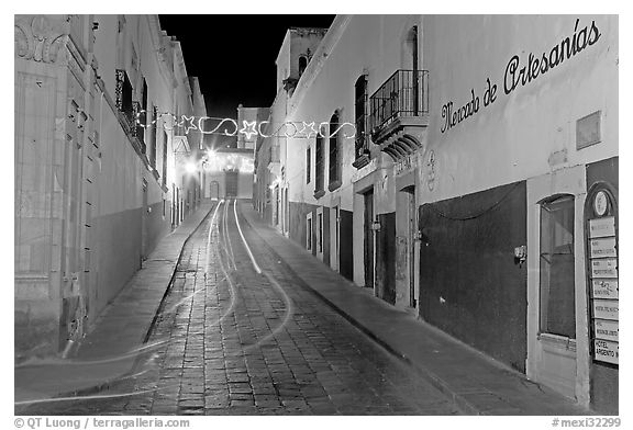 Uphill paved street by night with light trail. Zacatecas, Mexico