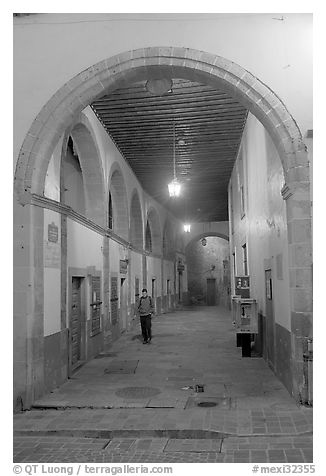 Man walking in an arched passage a dawn. Guanajuato, Mexico (black and white)