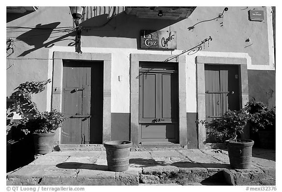 Blue doors and yellow wall on Plaza San Roque. Guanajuato, Mexico (black and white)