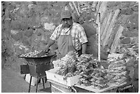 Man selling grilled peanuts on the street. Guanajuato, Mexico (black and white)