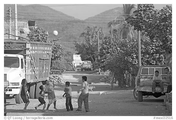 Children playing with a ball in village street. Mexico (black and white)