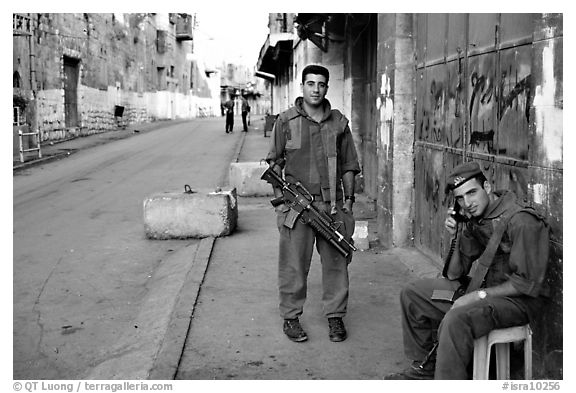 Two young israeli soldiers manning a checkpoint, Hebron. West Bank, Occupied Territories (Israel) (black and white)