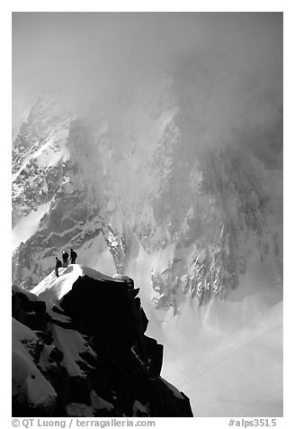 Alpinists on a buttress of Aiguille du Midi climbing the Cosmiques ridge. Alps, France
