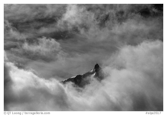 Aiguille du Midi summit emerges from the clouds. Alps, France