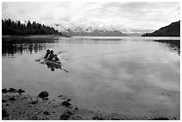 Kayakers paddle a double kayak in Hugh Miller Inlet. Glacier Bay National Park, Alaska (black and white)