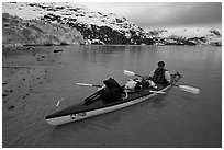 Kayaker sitting in loaded double kayak near Lamplugh Glacier. Glacier Bay National Park, Alaska (black and white)