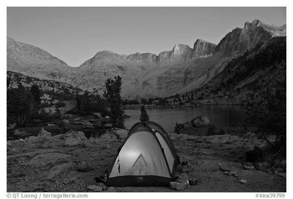 Tent with light and Palisades at dusk, lower Dusy Basin. Kings Canyon National Park (black and white)