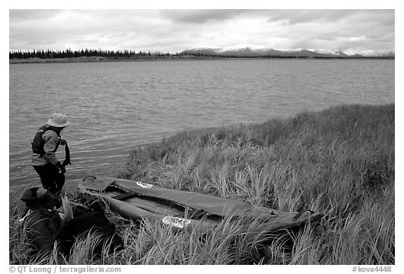 Canoeist deflating the canoe. Kobuk Valley National Park, Alaska