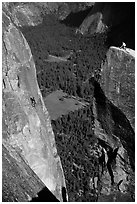 Climbers on Lost Arrow spire and Yosemite falls wall. Yosemite National Park, California (black and white)