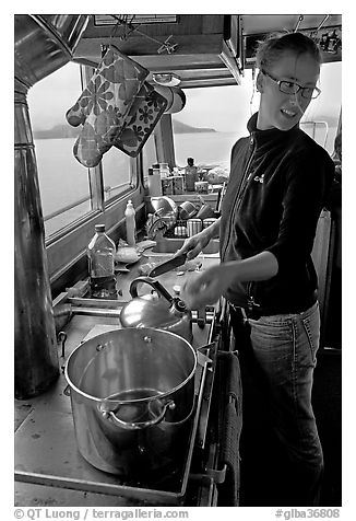Chef cooking aboard small boat. Glacier Bay National Park (black and white)