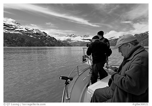 Film producer taking notes as crew films. Glacier Bay National Park (black and white)