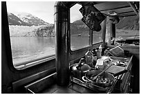 Breakfast potatoes in a small boat moored in front of glacier. Glacier Bay National Park, Alaska, USA. (black and white)