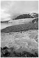 Stream flowing into Tarr Inlet, with Margerie Glacier in background. Glacier Bay National Park, Alaska, USA. (black and white)