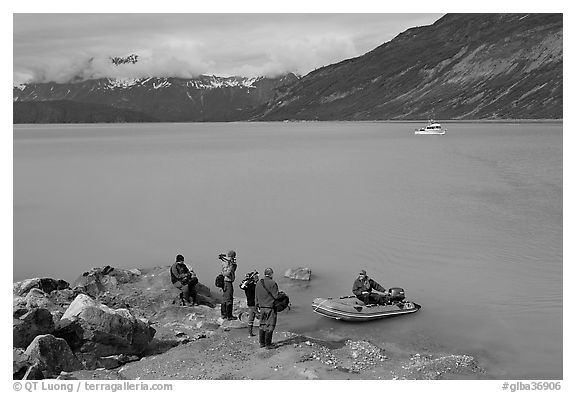 Film crew met by a skiff after shore excursion. Glacier Bay National Park (black and white)