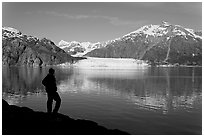 Man in silhouette looking at Tarr Inlet, Fairweather range and Margerie Glacier. Glacier Bay National Park, Alaska, USA. (black and white)