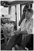 Captain sitting at the wheel. Glacier Bay National Park, Alaska, USA. (black and white)
