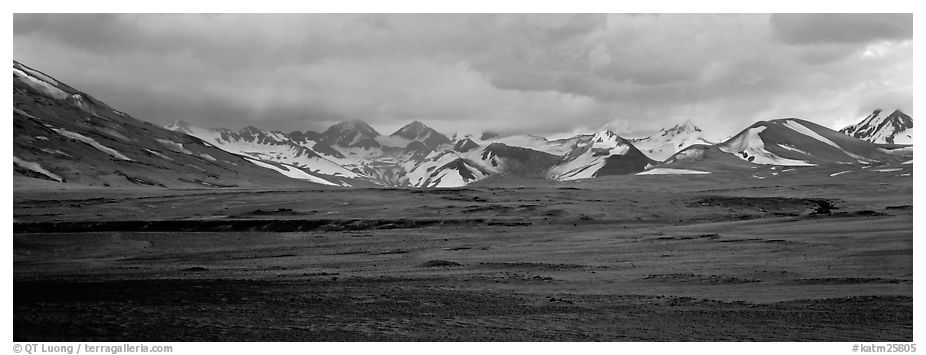 Desert-like ash-covered valley surrounded by snowy peaks. Katmai National Park (black and white)