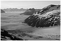 Craggy peaks, glacier, and sea of clouds. Kenai Fjords National Park, Alaska, USA. (black and white)